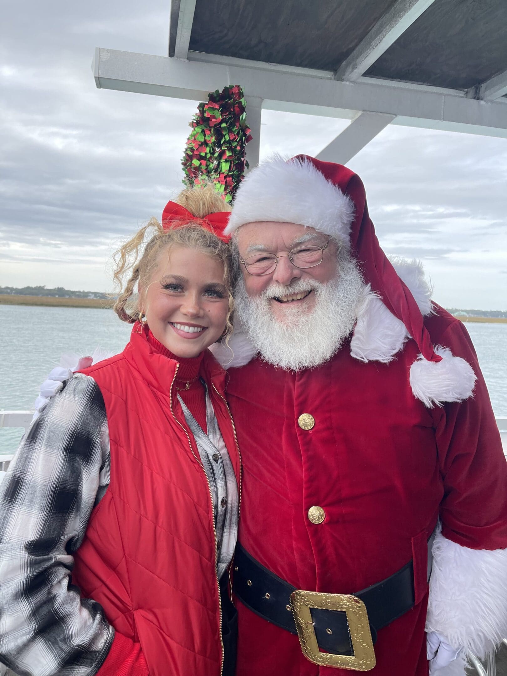 A woman and man dressed as santa claus